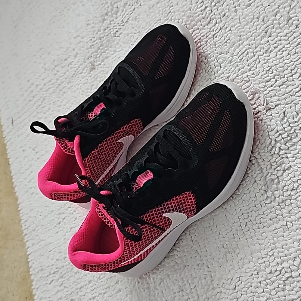 NWOT Nike Revolution's in Black and, fluorescent pink.  Never worn!  Size 7.5